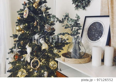 Christmas composition with decoration, christmas tree, gifts, snow and accessories in cozy home decor Christmas composition with decoration, christmas tree, gifts, snow and accessories in cozy home decor 97126552