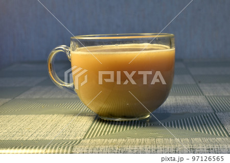 Tea with milk in a glass cup. 97126565