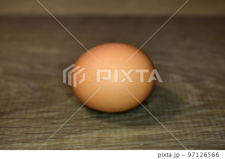 The chicken egg lies on the floor. 97126566