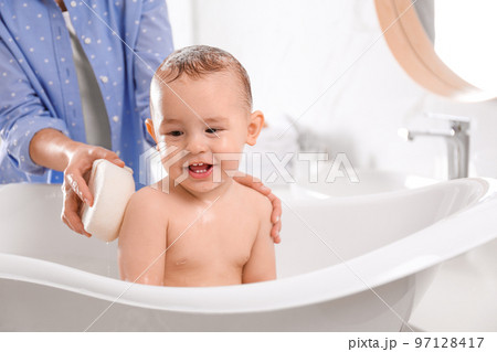 Mother with her little baby in bathroom Mother with her little baby in bathroom 97128417