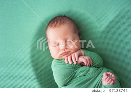 Newborn baby in green diaper is sleeping. Newborn baby in green diaper is sleeping. 97128745