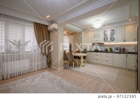 Classic beige kitchen with counter space and a variety of appliances 97132385