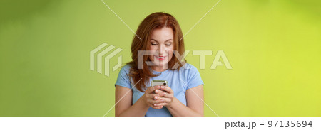 Intrigued excited tempting redhead middle-aged woman shopping online smartphone hold mobile phone look pleased entertained gadget screen smiling delighted playing game found perfect app Intrigued excited tempting redhead middle-aged woman shopping online smartphone hold mobile phone look pleased entertained gadget screen smiling delighted playing game found perfect app 97135694
