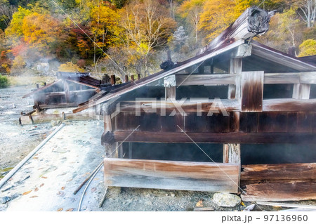 Old wooden onsen bath houses spa buildings in Nikko Japan 97136960