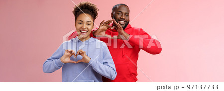 Charming joyful caring young african american family man woman siblings smiling broadly show heart gestures grinning express love empathy positivity, two loyal friends cherish friendship Charming joyful caring young african american family man woman siblings smiling broadly show heart gestures grinning express love empathy positivity, two loyal friends cherish friendship 97137733