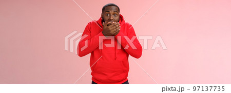 Shocked gasping surprised african-american guy overhear stunning rumour press palms mouth not slip word widen eyes impressed stunned unbeliavable amazing gossip, standing pink background 97137735