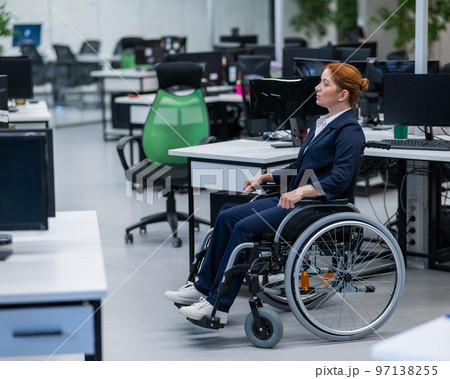 Caucasian woman wheelchair in open space office. Caucasian woman wheelchair in open space office. 97138255