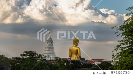 Back side view of Beautiful The Giant Golden Buddha Statue and White Pagada against the sky background. 97139750