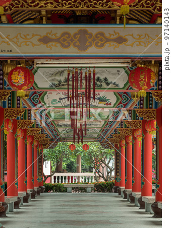 A diminishing perspective view of Pathway at Wat thamma katanyu. Scenic idyllic walkway in Taiwanese temple. 97140143