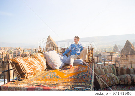 Happy young man on the roof in Cappadocia, Turkey 97141906
