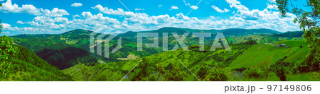 huge horizontal wide panorama of green Italian hills sunny day background huge horizontal wide panorama of green Italian hills sunny day background 97149806