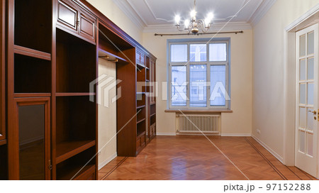 An empty room with a large window, rent, sale and furniture made of natural wood 97152288
