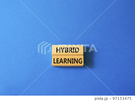Hybrid learning symbol. Concept word Hybrid learning on wooden blocks. Beautiful blue background. Business and Hybrid learning concept. Copy space 97153475