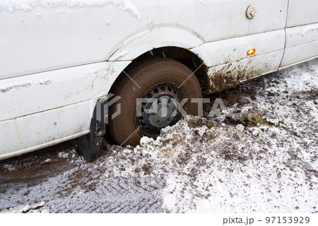 the car stalled in the mud in winter. minivan stalled in the mud. wrong, bad wheel tread for off road the car stalled in the mud in winter. minivan stalled in the mud. wrong, bad wheel tread for off road 97153929