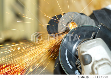 worker makes metal steel pipe grinding, close-up many sparks worker makes metal steel pipe grinding, close-up many sparks 97153996