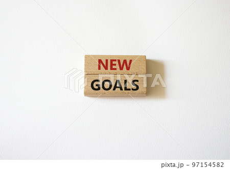 New goals symbol. Wooden blocks with words New goals. Beautiful white background. Business and New goals concept. Copy space. 97154582