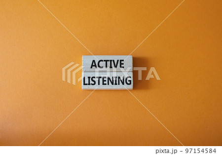 Active listening symbol. Wooden blocks with words Active listening. Beautiful orange background. Business and Active listening concept. Copy space. 97154584