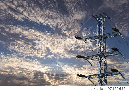 Electricity pylon (high voltage power line) against the background of a romantic evening sky Electricity pylon (high voltage power line) against the background of a romantic evening sky 97155635