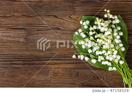 Bouquet of lilies of the valley on the wooden background 97156529
