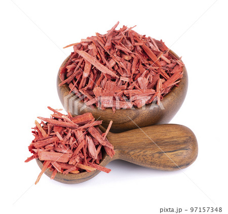 Red Sandalwood incense chips in wooden bowl and spoon, isolated on white background. Sanderswood, rubywood or red saunders. 97157348