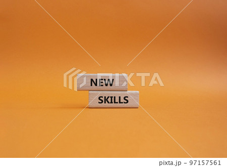 New skills symbol. Wooden blocks with words New skills. Beautiful orange background. Business and New skills concept. Copy space. 97157561