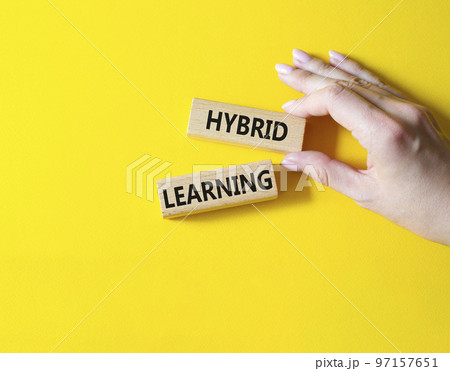 Hybrid learning symbol. Concept word Hybrid learning on wooden blocks. Beautiful yellow background. Business and Hybrid learning concept. Copy space Hybrid learning symbol. Concept word Hybrid learning on wooden blocks. Beautiful yellow background. Business and Hybrid learning concept. Copy space 97157651