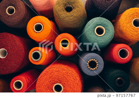 Composition of colorful vibrant wool threads from above. 97157767
