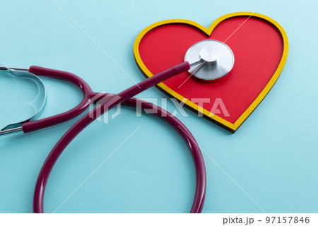 Red heart and stethoscope lies on a blue background 97157846