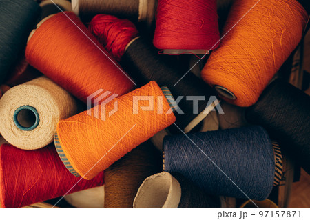 Composition of colorful vibrant wool threads from above. 97157871