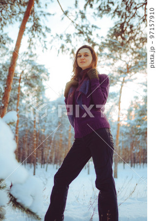 Young woman enjoying winter weather in the snow forest. 97157910