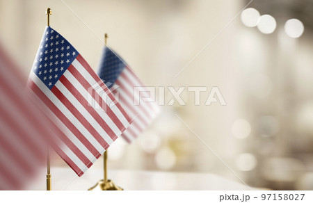 Small flags of the USA on an abstract blurry background 97158027