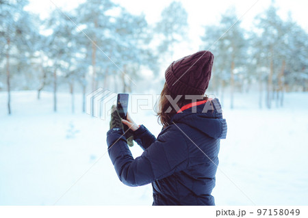 Young woman enjoying winter weather in the snow forest. 97158049