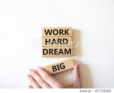 Work and dream symbol. Wooden blocks with words Work Hard Dream Big. Beautiful white background. Businessman hand. Business and Work Hard Dream Big concept. Copy space. Work and dream symbol. Wooden blocks with words Work Hard Dream Big. Beautiful white background. Businessman hand. Business and Work Hard Dream Big concept. Copy space. 97158460