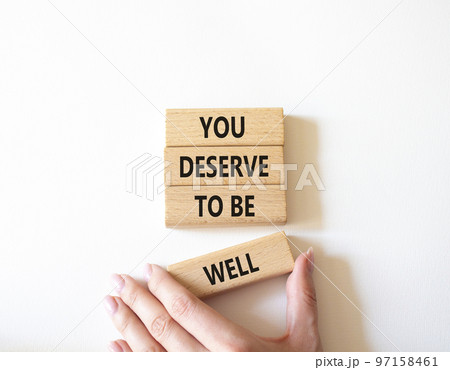 You deserve to be well symbol. Wooden blocks with words You deserve to be well. Beautiful white background. Businessman hand. You deserve to be well concept. Copy space. You deserve to be well symbol. Wooden blocks with words You deserve to be well. Beautiful white background. Businessman hand. You deserve to be well concept. Copy space. 97158461