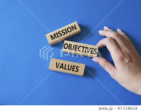 Mission Objectives Values symbol. Concept words Mission Objectives Values on wooden blocks. Beautiful blue background. Businessman hand. Business and Mission Objectives Values concept. Copy space Mission Objectives Values symbol. Concept words Mission Objectives Values on wooden blocks. Beautiful blue background. Businessman hand. Business and Mission Objectives Values concept. Copy space 97158628