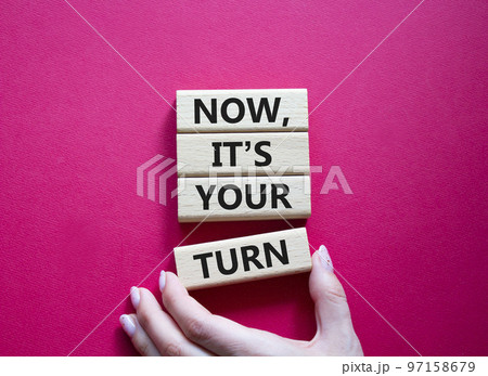 Now it's your turn symbol. Concept words Now it's your turn on wooden blocks. Beautiful red background. Businessman hand. Business and Now it's your turn me concept. Copy space 97158679