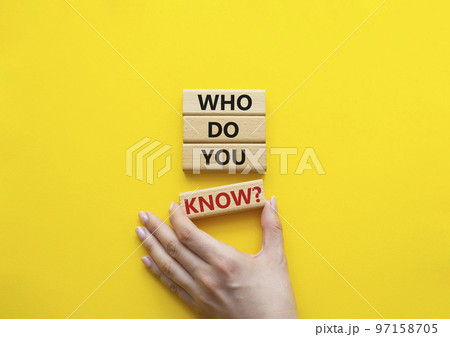Who do you know symbol. Concept words Who do you know on wooden blocks. Beautiful yellow background. Businessman hand. Business and Who do you know concept. Copy space 97158705
