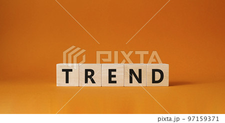 Trend symbol. Concept word Trend on wooden cubes. Beautiful orange background. Business and Trend concept. Copy space. 97159371