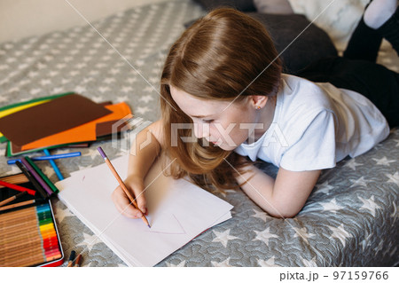 The girl after school plays at home, draws with pencils and felt-tip pens The girl after school plays at home, draws with pencils and felt-tip pens 97159766