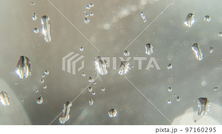 Raindrops fall on the window close-up. Rain, rainy, depressive, dreary weather. Wet drop water. Splashes of water with large drops on the glass. On window with water drops and splashes of water. Raindrops fall on the window close-up. Rain, rainy, depressive, dreary weather. Wet drop water. Splashes of water with large drops on the glass. On window with water drops and splashes of water. 97160295