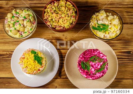 Set of festive mayonnaise salads on wooden table. Top view 97160334