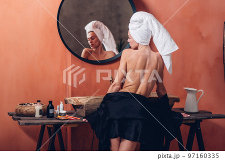 Woman in bathroom with open back and beautiful clean skin 97160335