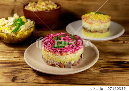 Set of festive mayonnaise salads on wooden table 97160336