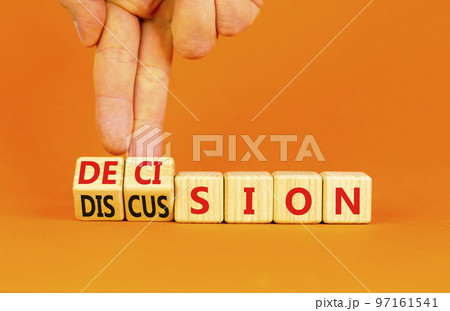 Discussion and decision symbol. Concept word Discussion and Decision on wooden cubes. Businessman hand. Beautiful orange table orange background. Business discussion and decision concept. Copy space. Discussion and decision symbol. Concept word Discussion and Decision on wooden cubes. Businessman hand. Beautiful orange table orange background. Business discussion and decision concept. Copy space. 97161541