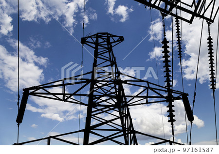 Electricity pylon (high voltage power line), black contour,  on the background of the cloudy sky 97161587