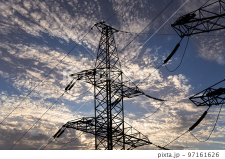 Electricity pylon (high voltage power line), black contour,  against the background of a romantic evening sky 97161626