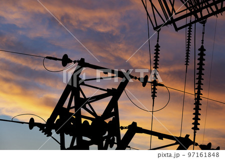 Electricity pylon (high voltage power line), black contour, against the background of a romantic evening sky Electricity pylon (high voltage power line), black contour, against the background of a romantic evening sky 97161848