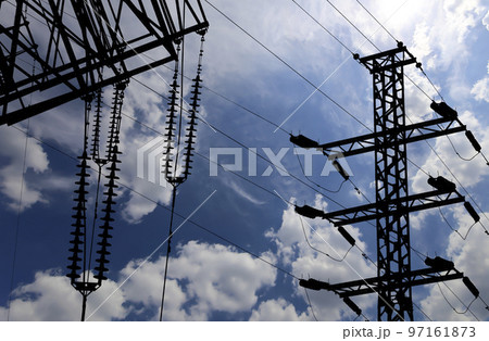 Electricity pylon (high voltage power line), black contour,  on the background of the cloudy sky 97161873