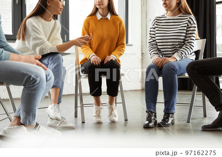 Psychotherapist working with patients in group therapy session, closeup 97162275