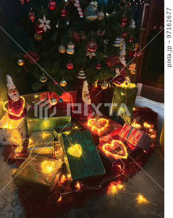 Many gift boxes tied with glowing heart shape lights 97162677